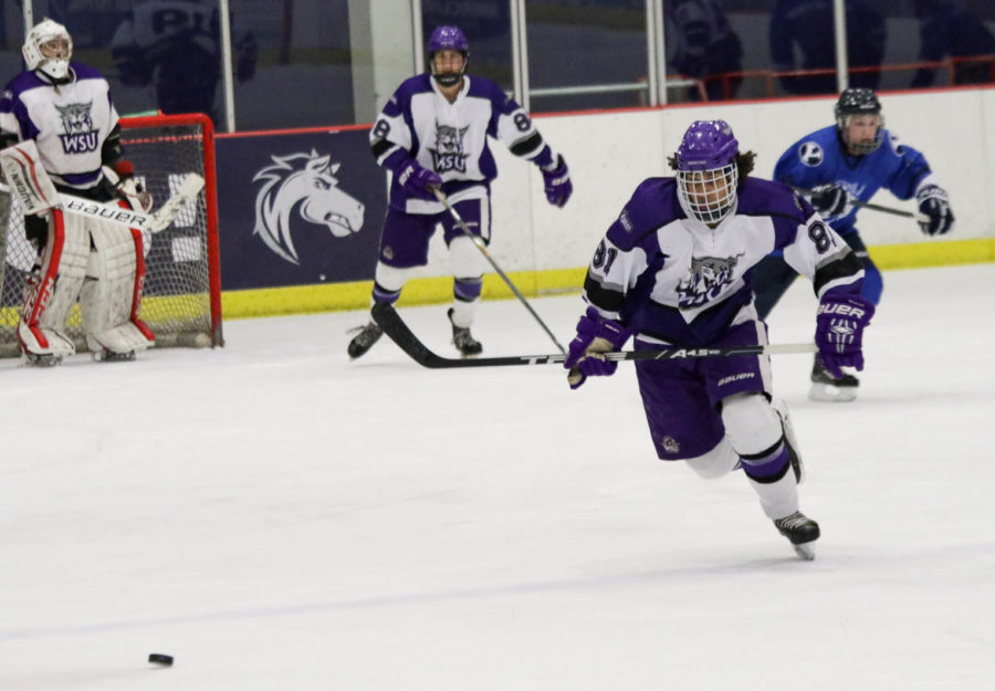 Forward Zak Tollet sprints towards the puck to drive it down the rink during the game on Saturday night.  (Ariana Berkemeier / The Signpost)