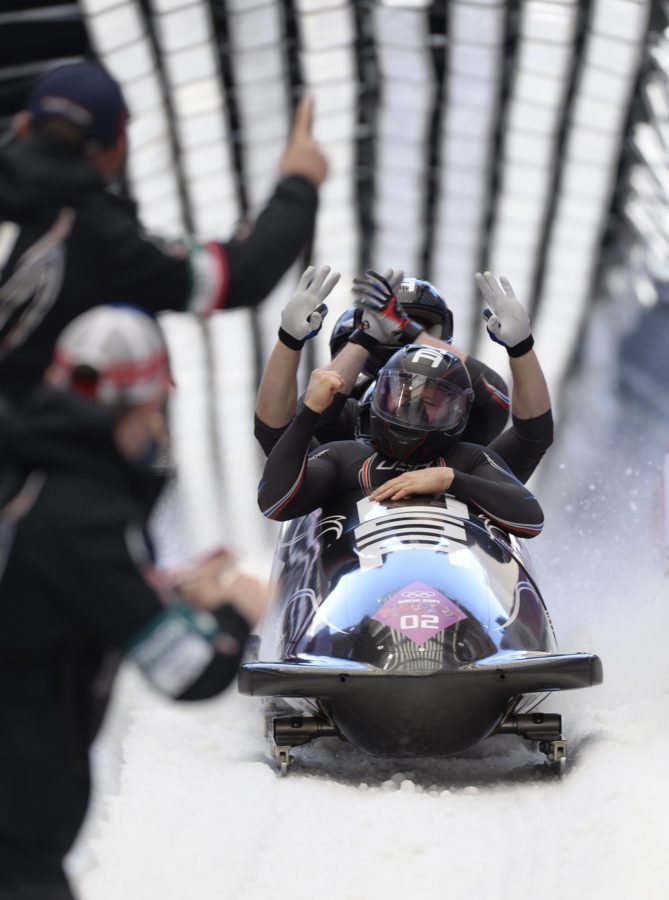 The USA- 1 bobsled team, including driver Steven Holcomb, front, celebrate as they enter the finish area during the four-man bobsled event at the Winter Olympics in Sochi, Russia, on Sunday, Feb. 23, 2014. (Mark Reis/Colorado Springs Gazette/MCT)