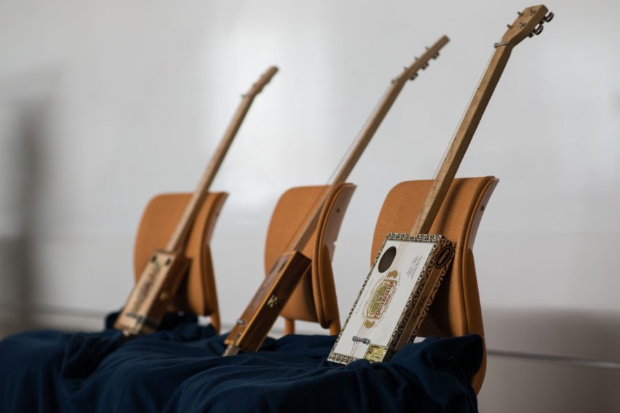 Three cigar-box guitars on display during the presentation. (Joshua Wineholt / The Signpost)