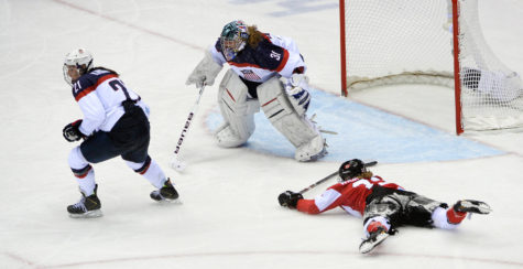 Hilary Knight, left, of the U.S. draws a penalty for cross-checking Canada's Hayley Wickenheiser in overtime during the women's hockey final at the Winter Olympics in Sochi, Russia, on Thursday, Feb. 20, 2014. Canada won, 3-2, in overtime. (Mark Reis/Colorado Springs Gazette/MCT)