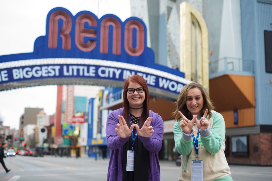 Managing editor Cydnee Green, left, and photographer Ariana Berkemeier, right, pose for a photo in front of the Reno sign. (Joshua Wineholt / The Signpost)