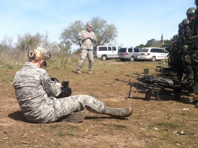 Senior Airman (Airman First Class at time of photo) Kara Mitchell shooting video during a military exercise on Camp Bullis.