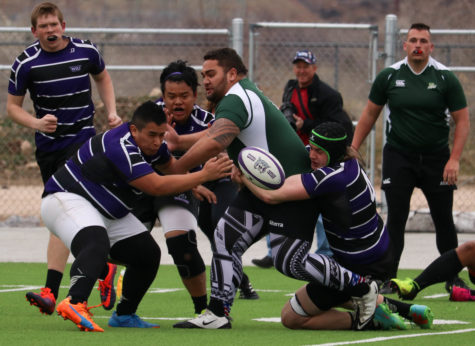 Three Weber State players force the ball out from a Utah Valley player Feb 18. (Abby Van Ess / The Signpost)