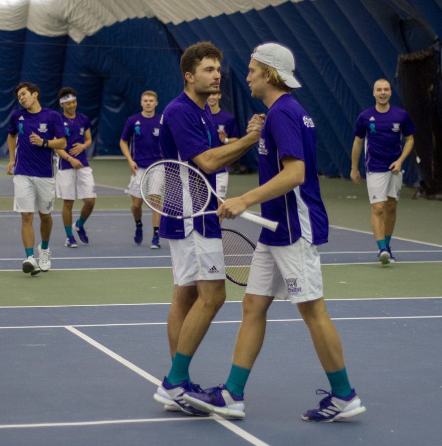 Stefan Cooper and Kris Van Wyk clenching their doubles match 6-4 and winning the doubles point for Weber to go up 1-0. (Sara Parker / The Signpost)