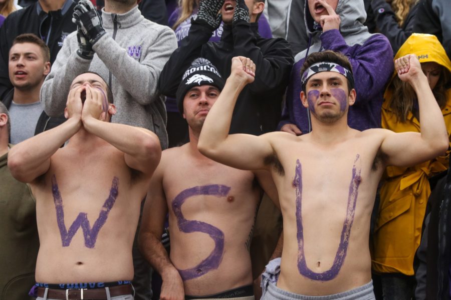 Shirtless fans show their school spirit, despite the cold and wet conditions of the night. (Ariana Berkemeier / The Signpost)