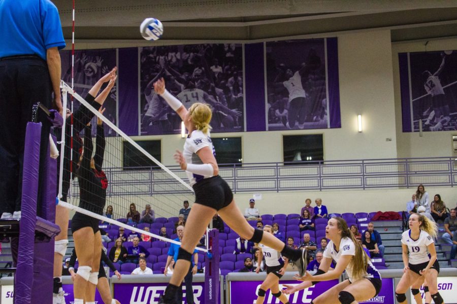 #1 Rylin Roberts lightly taps the ball over the net towards opponents SUU. (Sara Parker / The Signpost)