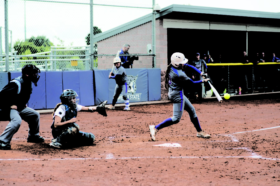 Courtney Petska, Wildcat outfielder, connects with the ball. (Joshua Wineholt / The Signpost)