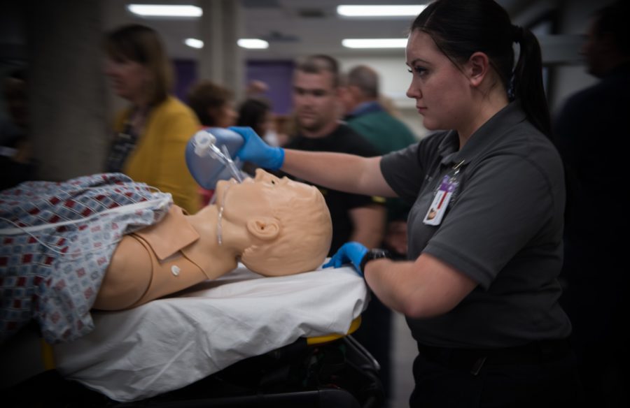 Kami May-Tolentino rushes a training dummy patient into one of the doctors offices found in the Marriott Health Science Buildings newly renovated Simulation Center as part of a demonstration of the training the facility provides to students. (Joshua Wineholt / The Signpost)
