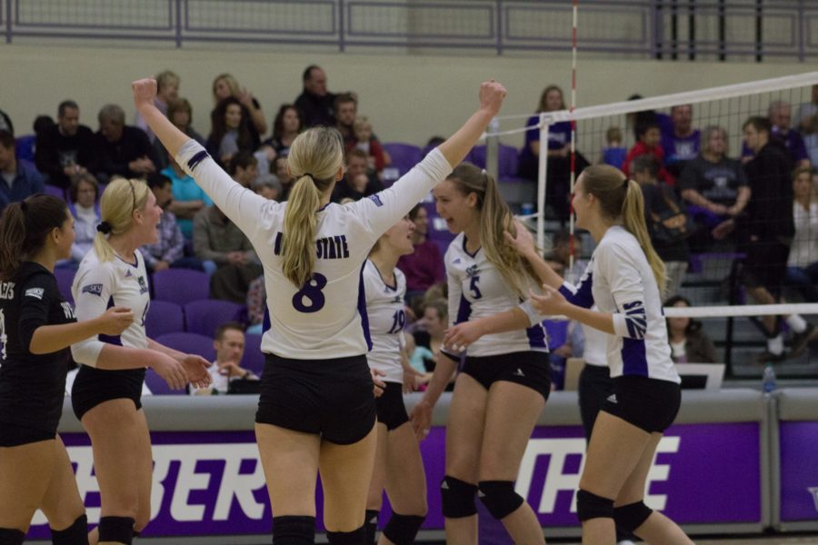 The Weber State Volleyball team celebrates a score against Portland State. (Kelly Watkins / The Signpost)