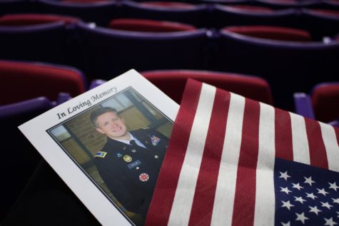 Program and flag handed out at the front door In Loving Memory of Maj. Brent Taylor. (Bella Torres / The Signpost).