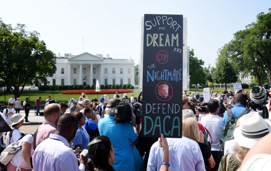 Protesters hold up signs during a rally supporting Deferred Action for Childhood Arrivals, or DACA, outside the White House on Sept. 5, 2017. (Olivier Douliery/Abaca Press/TNS)