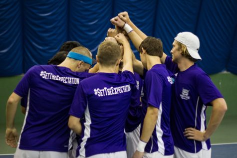 The mens tennis team cheering before they go into their doubles matches. (Sara Parker / The Signpost)