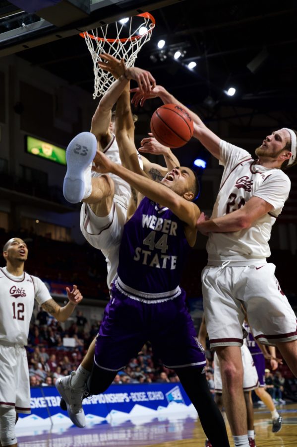 Braxton is blocked by two defenders, though the block resulted in a foul by the Griz. Photo credit: Joshua Wineholt