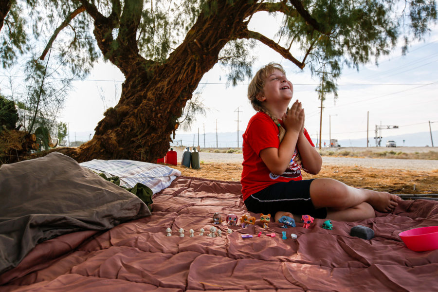 Brooke Thompson, 8, plays on the sleeping bag that her family slept in after a pair of earthquakes drove them out of their home. (Irfan Khan/Los Angeles Times/TNS)