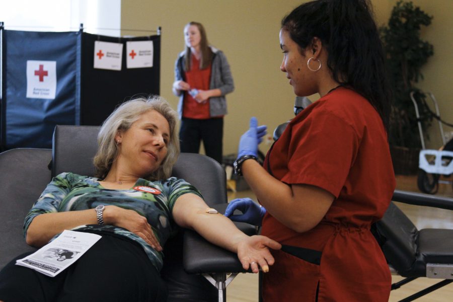 Michelle Paustenbaugh, Professor of Chemistry at Weber State University, gets bandaged by Melissa Dickson, of the American Red Cross, after getting her blood drawn for Weber State University's blood drive on Thursday, Sept 1. (Emily Crooks / The Signpost)