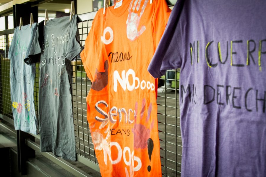 Shirts line the stairs in the student union building. An orange shirt is painted saying No means no. Silence means NO. (Kalie Pead/ The Signpost)