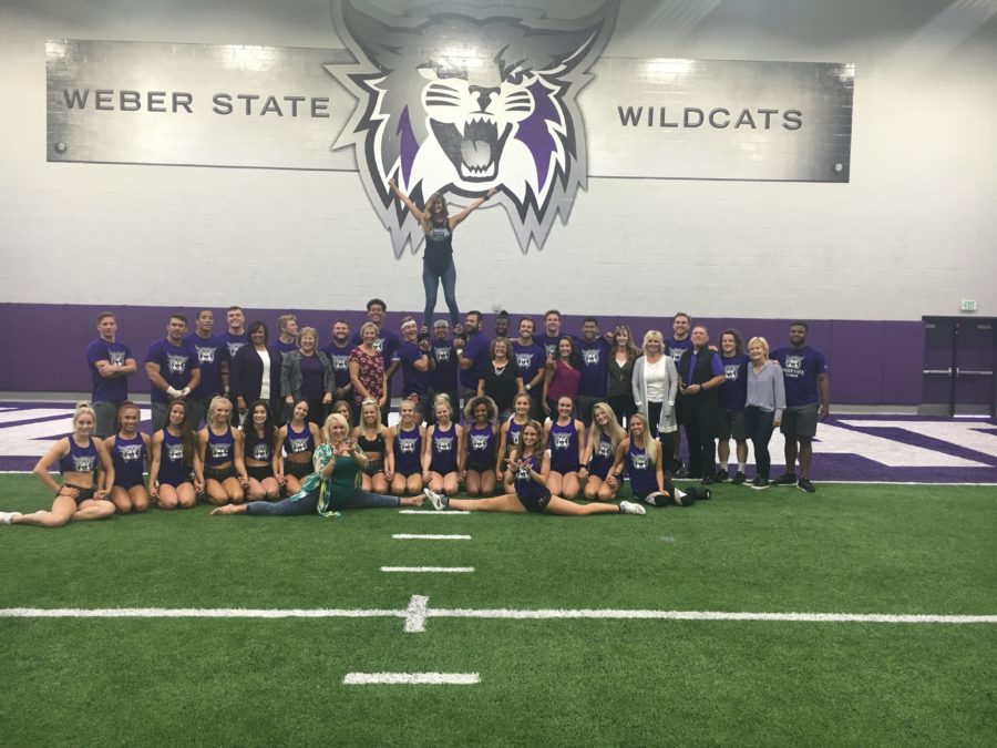 Alums and current Weber State cheerleaders pose in formation on Sept. 27 at the Weber State Fieldhouse after cheer reunion practice.(Weston Sleight/ The Signpost)