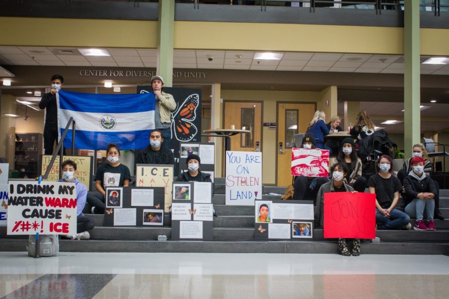 Students protest with posters and a flag on the steps inside the Shepherd Union Building. (Kalie Pead/ The Signpost)