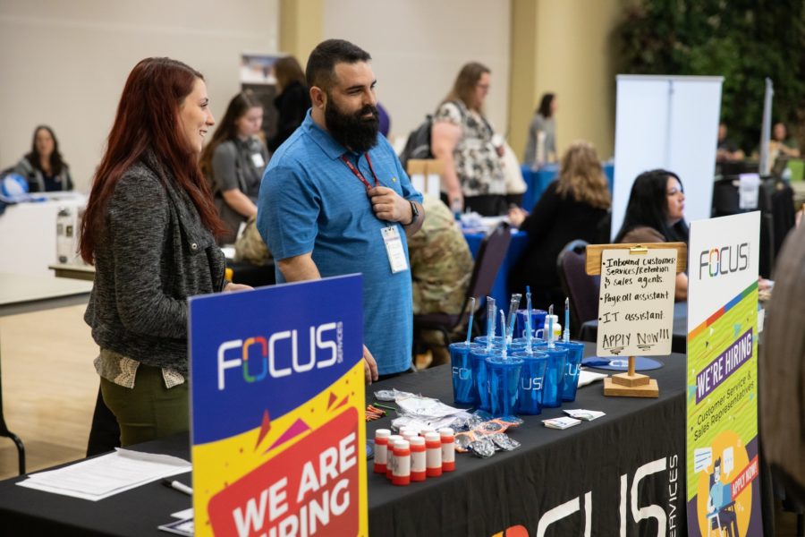 Jacqueline Auffant and Armando Zubia, representatives for Focus Services, look to recruit Weber State students at the Spring Career and Internship Fair held on Tuesday at WSUs main campus. (Robert Lewis / The Signpost)