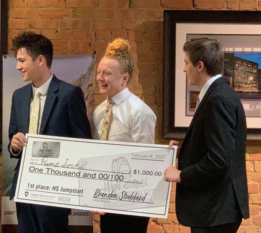 The team behind Pump Socks collects their cash award for placing first in the High School Jumpstart competition. (Adam Rubin / The Signpost)