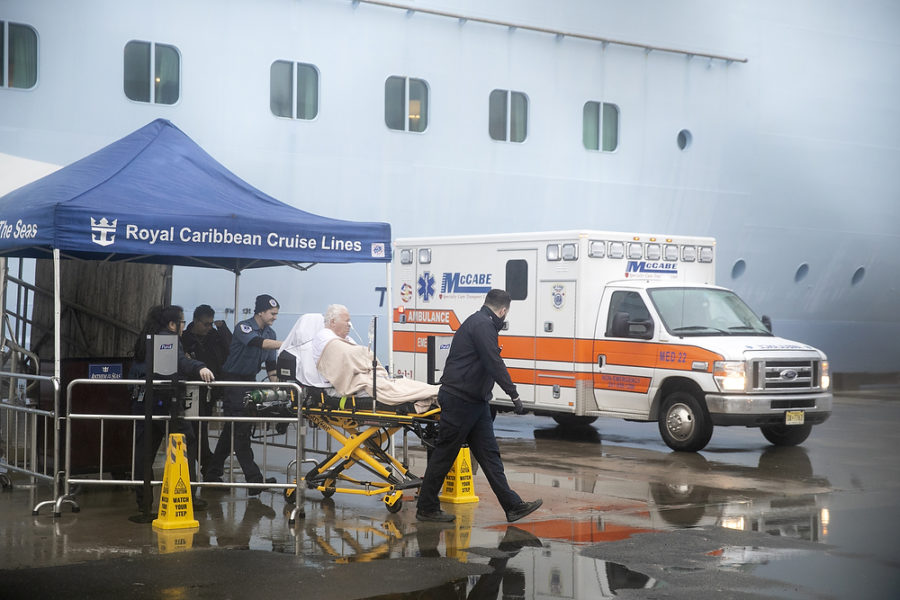 A man is escorted out of the ship on a stretcher to a waiting ambulance. The Anthem of the Seas docked in New Jersey early Friday. The coronavirus screening is being ordered as a precaution after passengers became ill. Friday, February 7, 2020. Bayonne, NJ USA