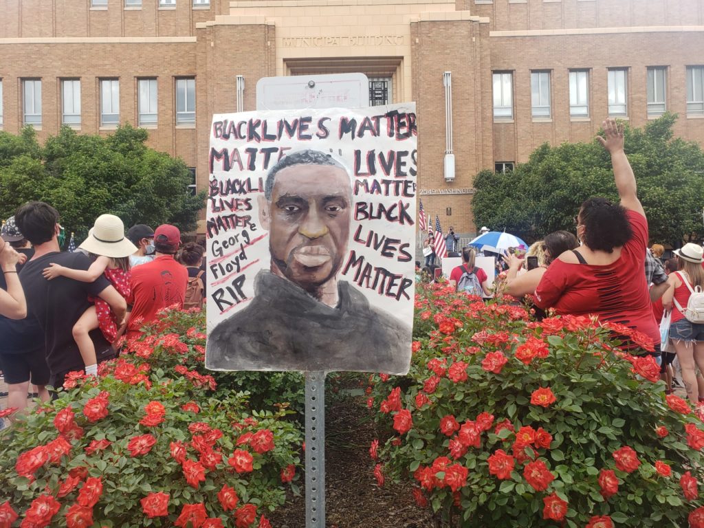 A drawing of George Floyd sits taped over a sign in front of the Ogden/Weber Municipal Building. (Francia Benson).