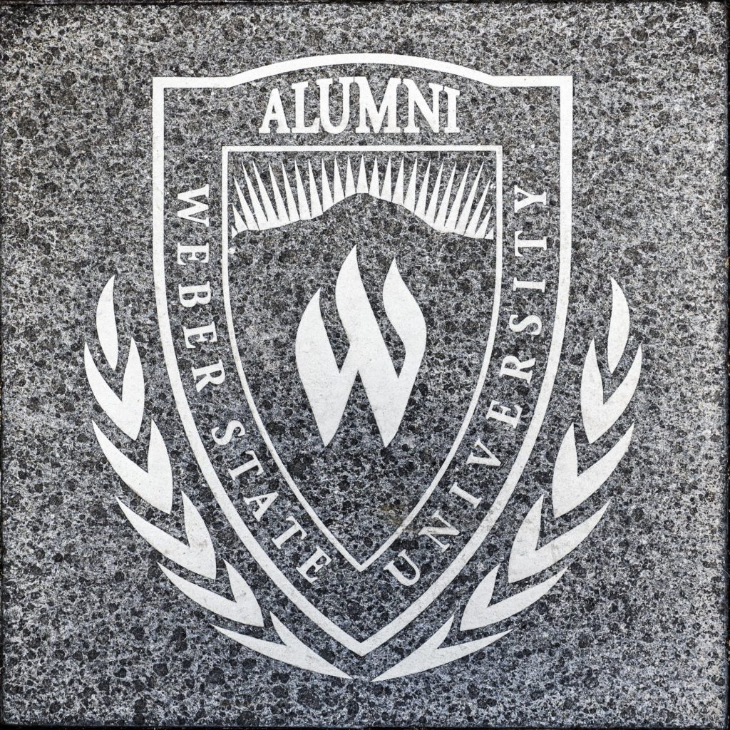 Weber State University Alumni Association plaque located outside and at the top of the stairs leading to the Lindquist Alumni Center. (RobertLewis/The Signpost)