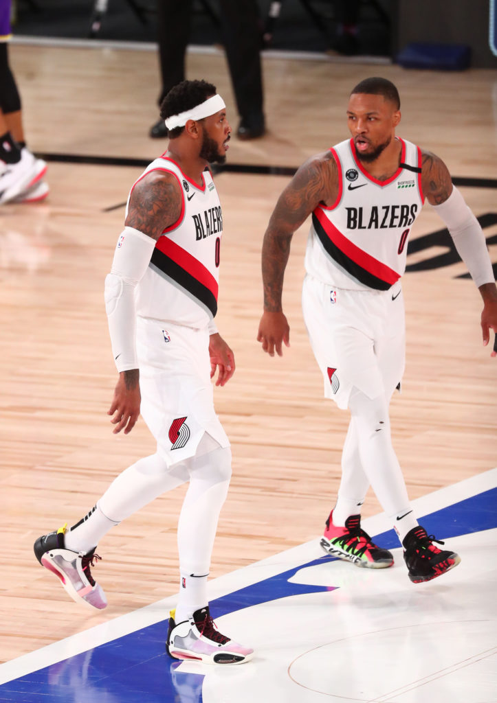 The Portland Trail Blazers' Damian Lillard (0) and Carmelo Anthony (00) talk in the second half against Los Angeles Lakers of Game 3 in the first round of the NBA Playoffs at the AdventHealth Arena at the ESPN Wide World Of Sports Complex in Lake Buena Vista, Florida, on Saturday, Aug. 22, 2020. The Lakers won, 116-108, for a 2-1 series lead. (Kim Klement/Pool/Getty Images/TNS)