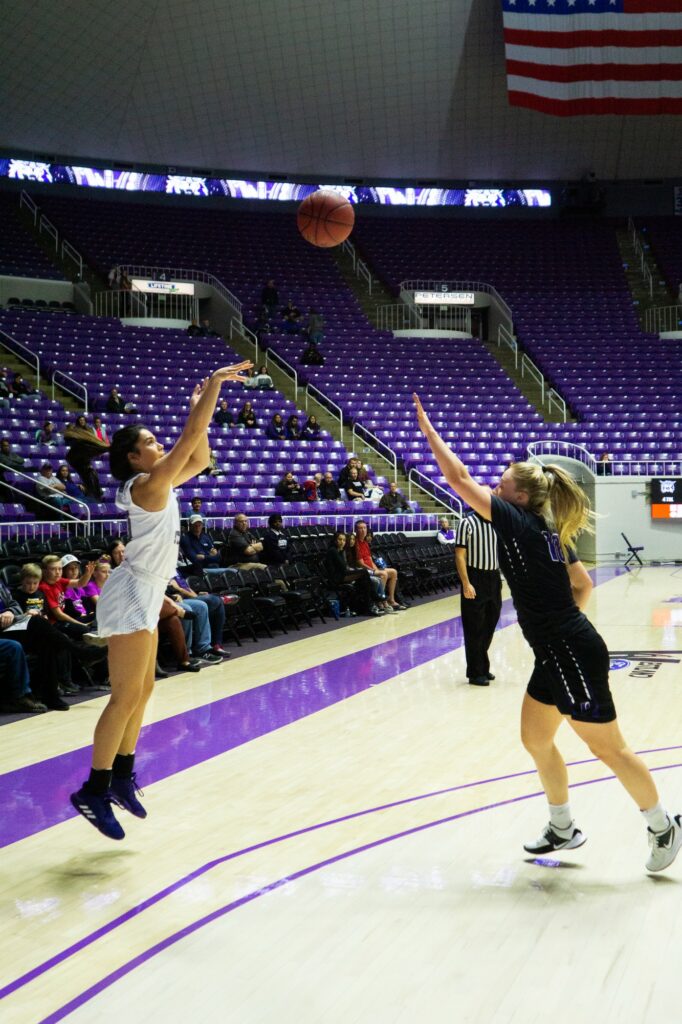 Ula Chamberlin goes for the three-pointer (Israel Campa / The Signpost)