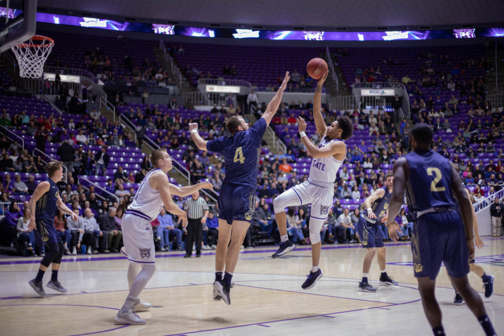 Cody John attempting a shot over MSU player Sam Neumann (4). (Marissa Wolford / The Signpost)