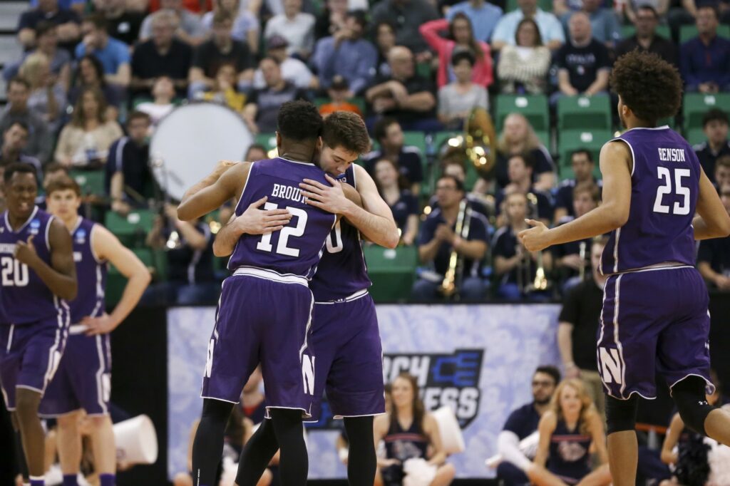 Northwestern's Bryant McIntosh (30) hugs teammate Isiah Brown (12) in the final seconds of a 79-73 against Gonzaga in the second round of the NCAA Tournament at Vivint Smart Home Arena in Salt Lake City on Saturday, March 18, 2017. (Armando L. Sanchez/Chicago Tribune/TNS)
