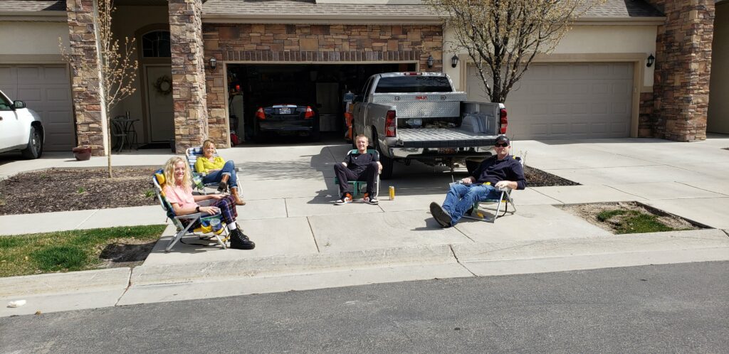 Four people have used a tape measure to make sure they are sitting six feet apart. (Kandice Harris)