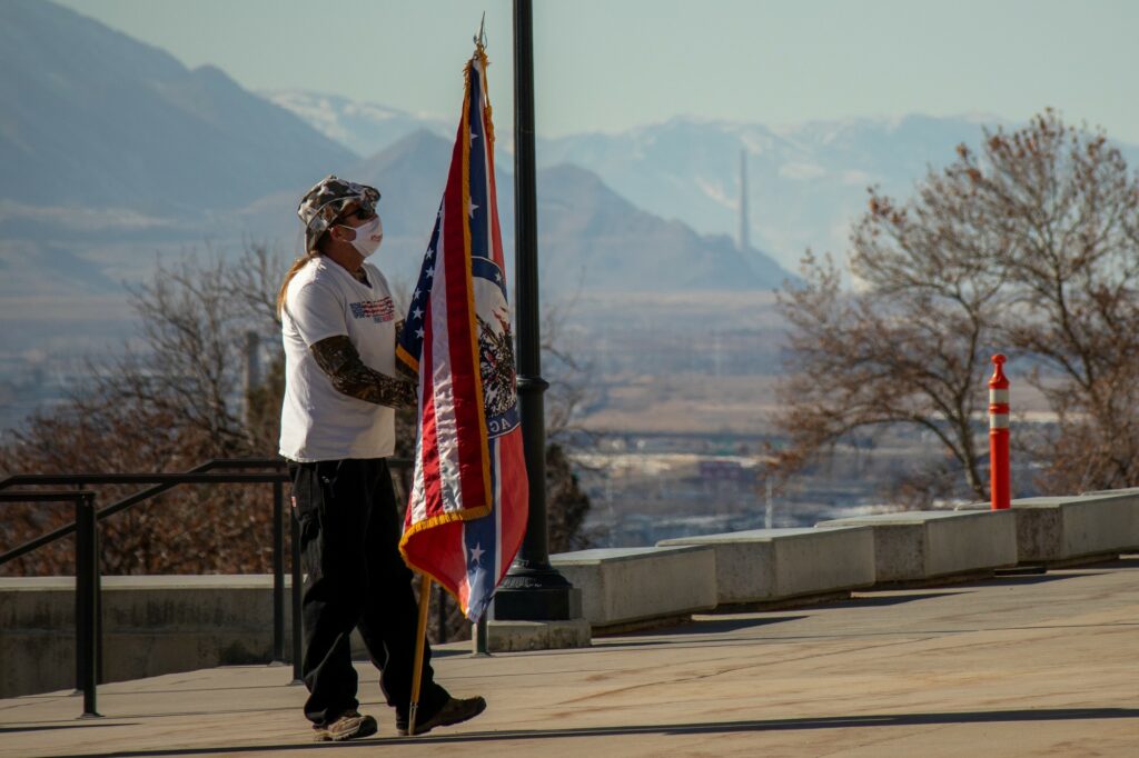 Lone protestor stands at the steps of Utah Capitol Jan. 20, 2021. (Sarah Earnshaw/ The Signpost)