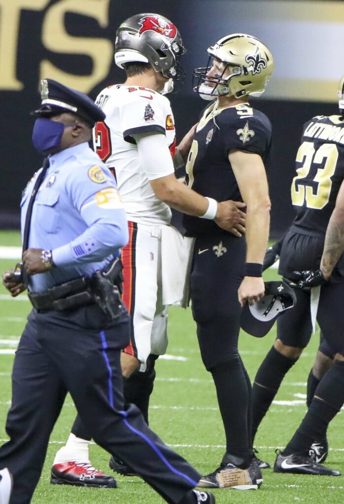 Tampa Bay Buccaneers quarterback Tom Brady (12), left, hugs New Orleans Saints quarterback Drew Brees (9) after the Buccaneers lost 34-23 to the Saints on Sept. 13, 2020 in New Orleans, Louisiana. (Dirk Shadd/Tampa Bay Times/TNS)