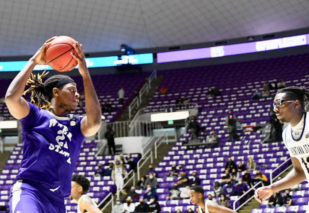 Dontay Bassett, center for WSU, passes the ball, resulting in 2 points.  Nikki Dorber / The Signpost