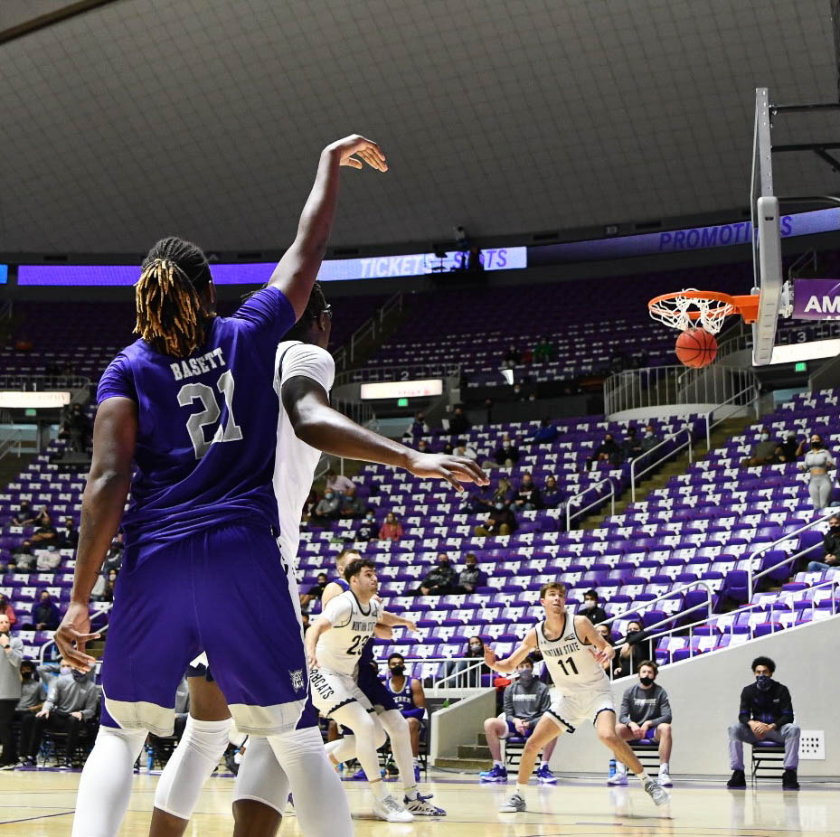 Tossing in a 3-pointer, Dontay Bassett adds to the win for the Wildcats in Saturday's game.  Nikki Dorber / The Signpost