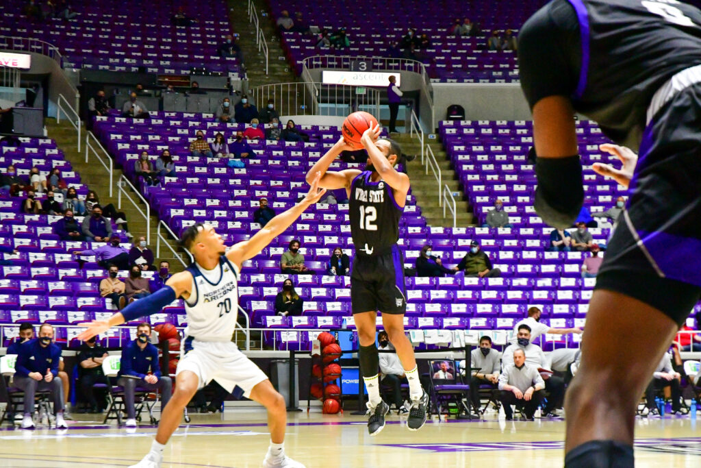 Isiah Brown, number 12, continues to throw threes throughout Saturday's game against Northern Arizona.  (Nikki Dorber / The Signpost)