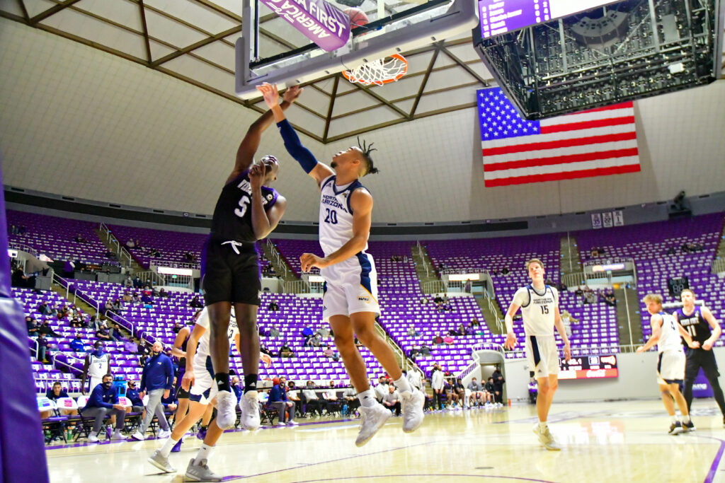 Weber State's Sisoho Jawara with a 2 point bucket in Saturday's game against Northern Arizona.  (Nikki Dorber / The Signpost)