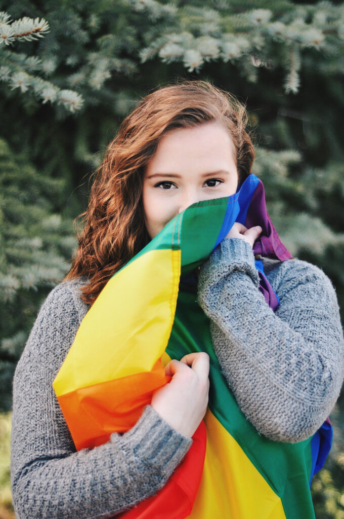 Ashlyn Rose wraps herself in a pride flag Sunday, Mar. 14, 2021, in Ogden, Utah. (Brooklynn Kilgore/ The Signpost)