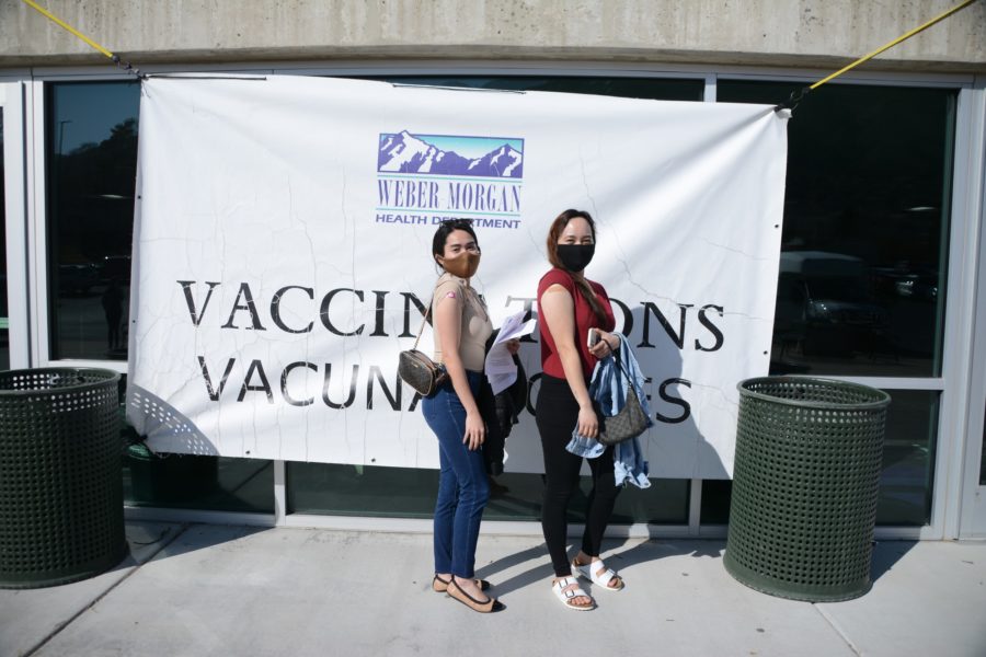 Bea Lois Delos Reyes and Sherwin Calabio show off their new bandaids after receiving their first COVID-19 vaccination on Mar. 16 in Ogden, Utah. They are just two of over 1600 vaccinations administered daily. (Brooklynn Kilgore/The Signpost) Photo credit: Brooklynn Kilgore