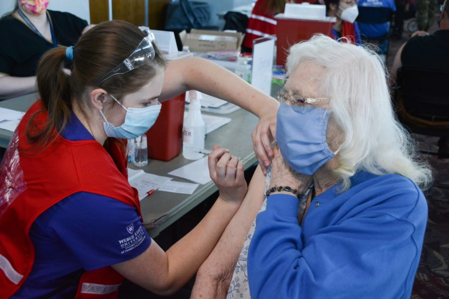 Weber State University nursing student Necia Wallenmeyer administers a COVID-19 vaccination to Lorna Ricks, Tuesday Mar. 16, in Ogden, Utah. (Brooklynn Kilgore/The Signpost)