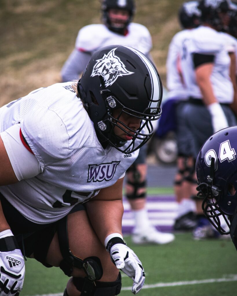 WSU O-lineman running drills during practice at Stewart Stadium.