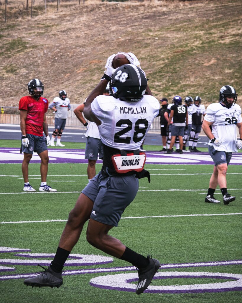 Wildcat running back Dontae McMillan catches a pass out of the backfield in practice at Stewart Stadium.