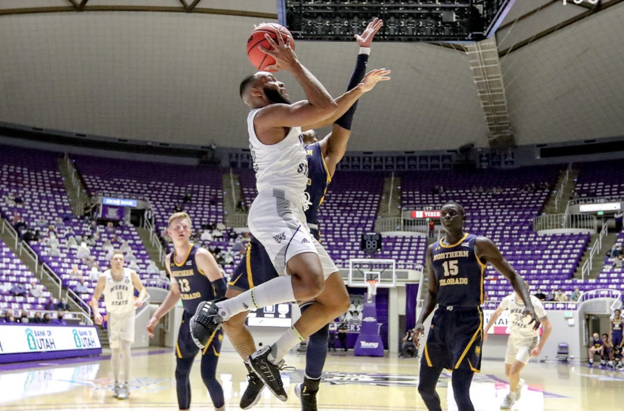 Wildcats guard Isiah Brown taking the basketball to the hoop through traffic against NCU. Photo credit: Weber State Athletics
