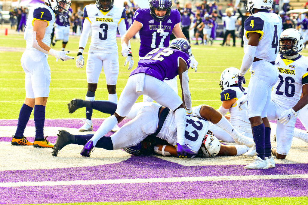 Weber State University's Rasheed Shaheed, 22, ensuring Justin Malone, 88, caught the ball during a Hail Mary that gave WSU their win during the game on Saturday March 27 against Northern Arizona University. Nikki Dorber/The Signpost