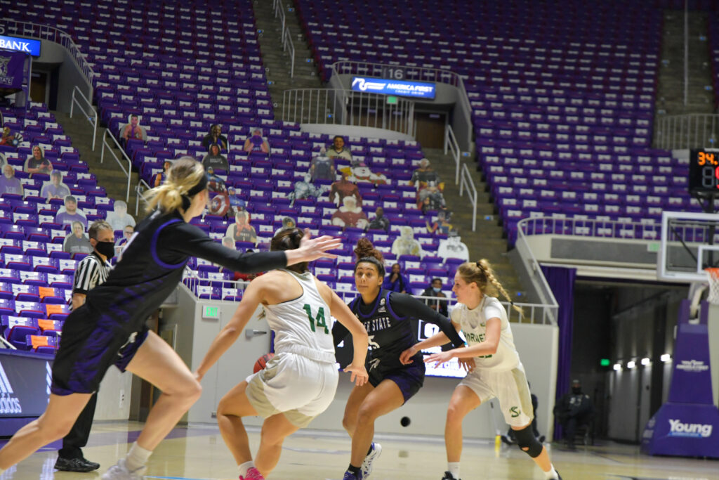 Daryn Hickok makes her way down the court, fighting off Sacramento Hornets in Saturday's game which resulted in an overtime win of 75-69. The game is the final home game for the Lady Wildcats for this season. (Nikki Dorber/The Signpost)