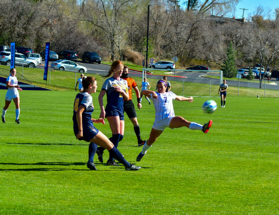Mylee Broad, 7,  jumps to keep control of the ball, despite Northern Colorados coverage. (Nikki Dorber/The Signpost)