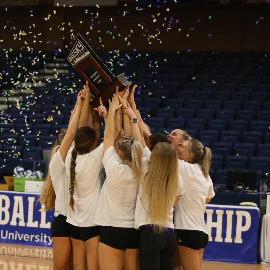 The Wildcats volleyball team hoists up the Big Sky Tournament Championship Trophy in Greeley, Colorado on April 2. Photo credit: Weber State Athletics