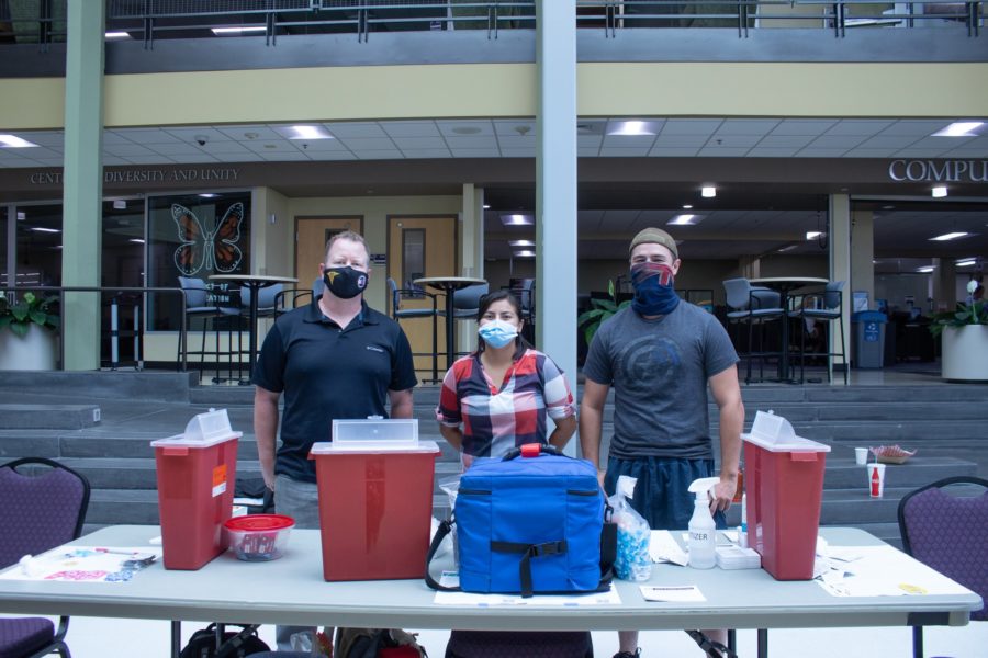 From left to right Spencer Lowe, Stephanie Young and Shane Miller prepare to give people their COVID vaccines in the Shepherd Union Building. (Kennedy Robins / The Signpost)