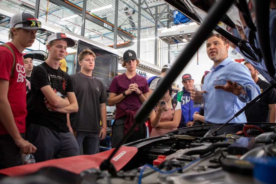 Weber State University instructor Blair Newbold shows students from Roy High School around the electric vehicle garage at Weber States Davis Campus on Sept. 17. Photo credit: Weber State University